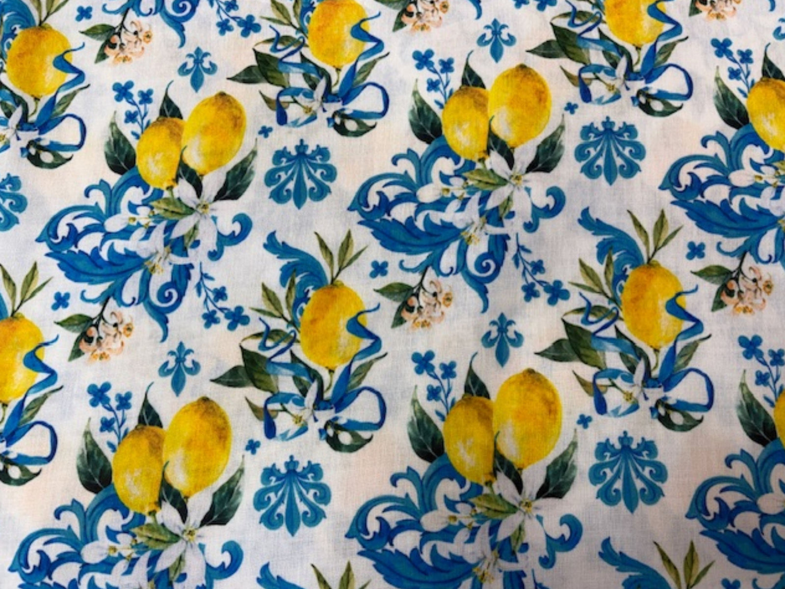 Yellow and green Mediterranean lemon print linen fabric from Cheap Fabrics, showing a vibrant citrus-themed textile with detailed lemon illustrations.
