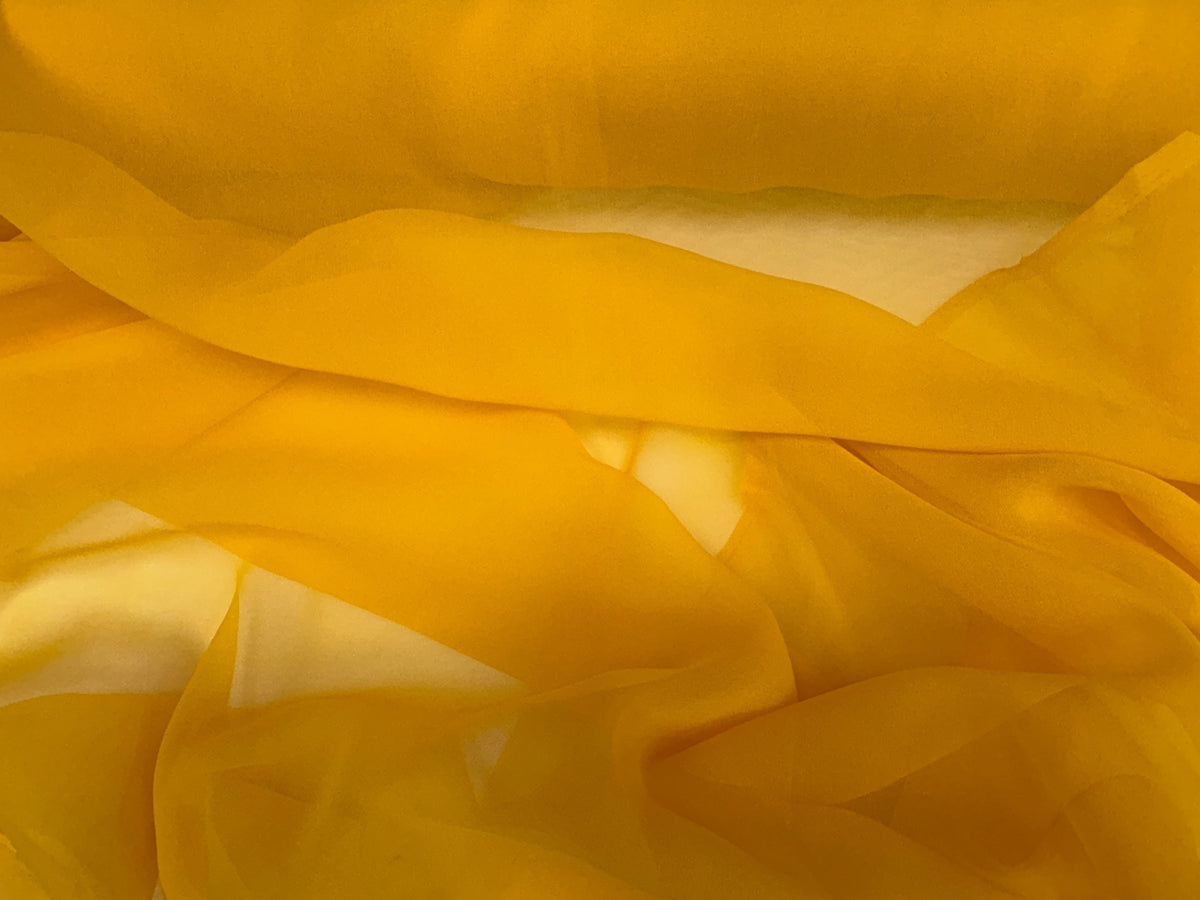 Soft yellow chiffon fabric from Cheap Fabrics, lightweight and sheer material ideal for dresses and elegant garments.