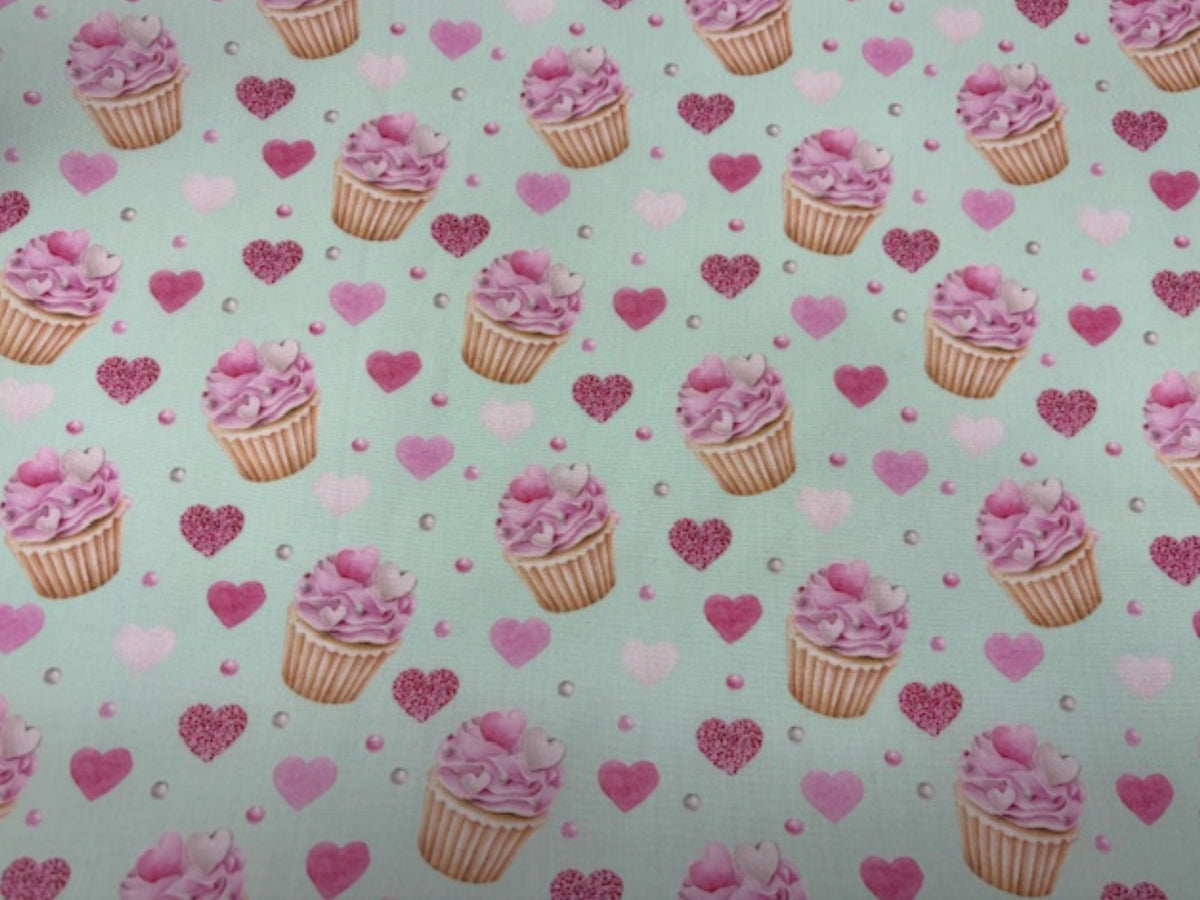 Polycotton fabric with an afternoon tea and cupcakes print in pale mint, ideal for quilting and craft projects by Cheap Fabrics.