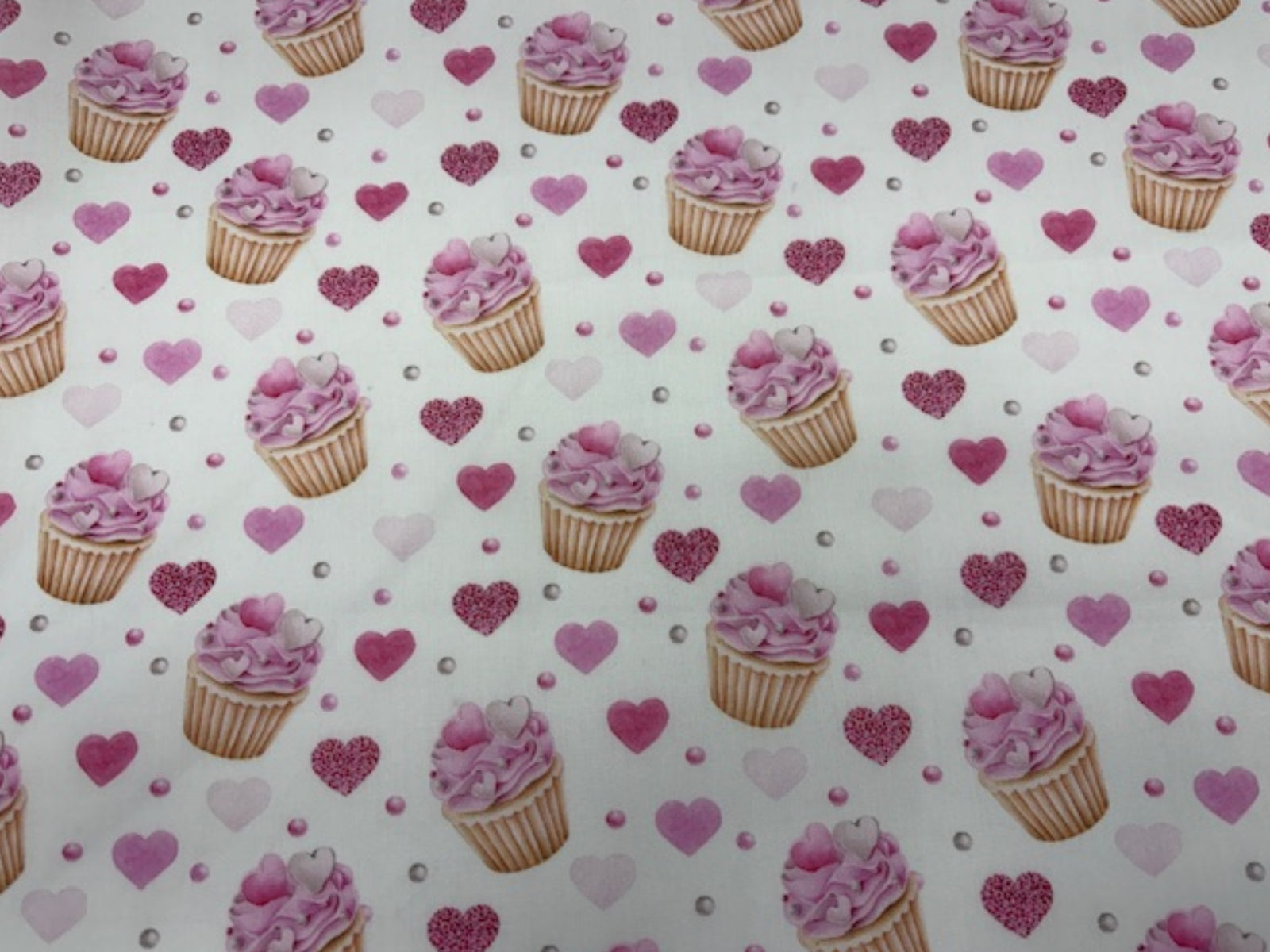 Poly/cotton fabric with afternoon tea and cupcake print in white, perfect for quilting or sewing projects by Cheap Fabrics.