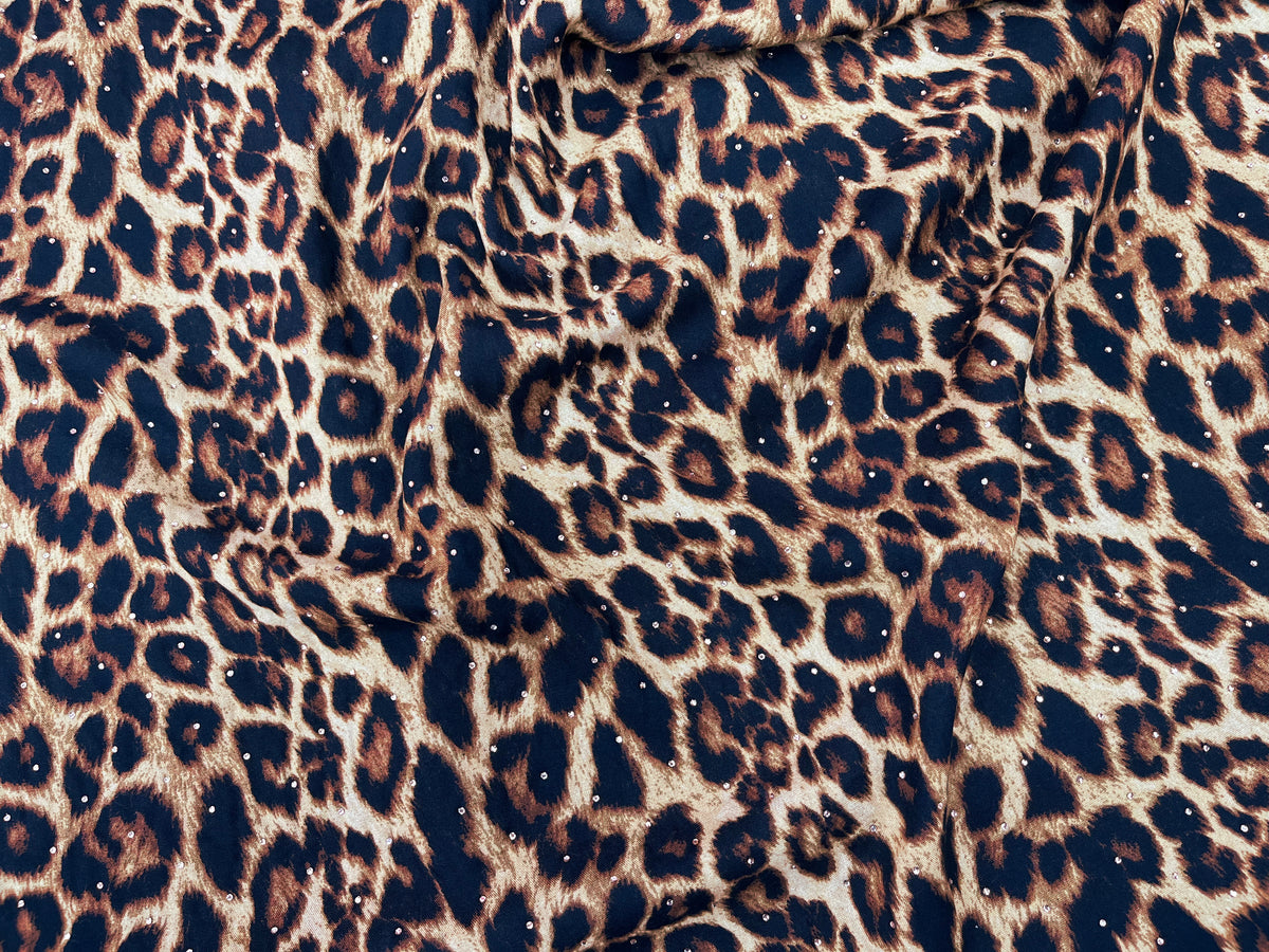 Animal Magic Dew Drop printed viscose fabric in brown, featuring colorful animal and floral patterns on soft viscose material.