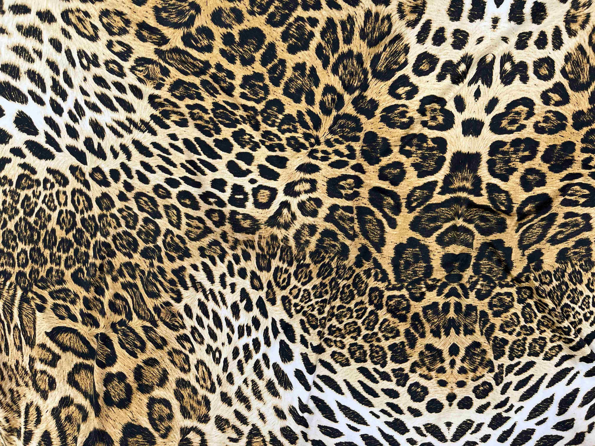 Brown and gold animal printed jersey fabric by Cheapfabrics, showing a soft, stretchy textile with jungle-inspired animal patterns.