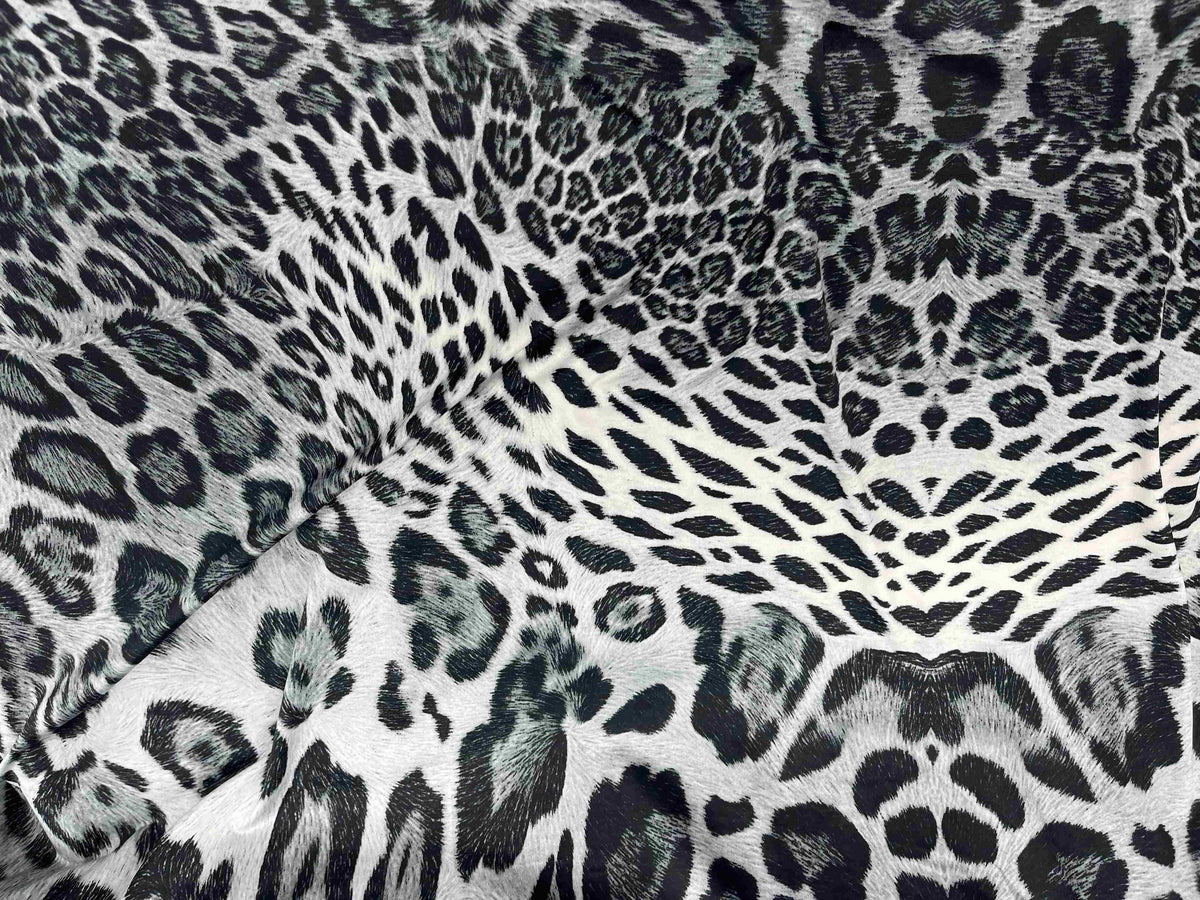 Gray animal printed jersey fabric by Cheapfabrics, soft textile with playful animal designs on smooth jersey material.