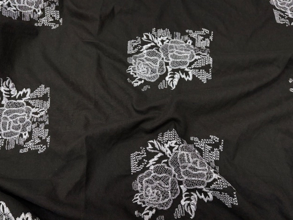 Black large 19cm rose motif faux linen fabric with color transfer defect, from Cheap Fabrics, showcasing the damaged textile surface.