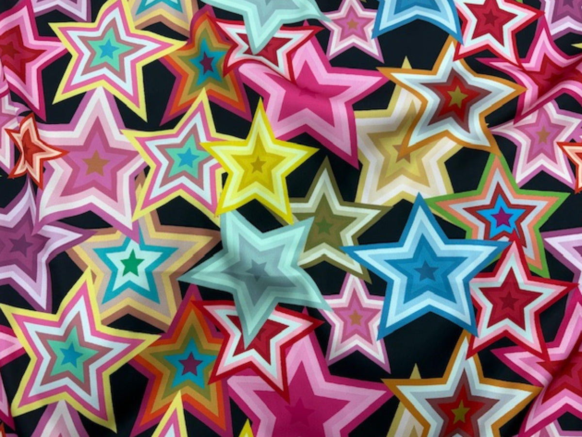 Black satin fabric with bold retro star pattern, Luxe Satin by Cheap Fabrics, showing smooth, shiny material with star design.