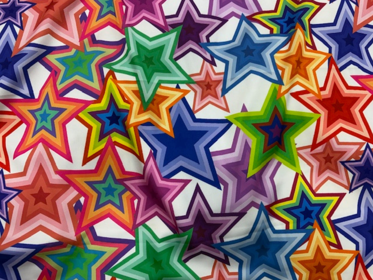 Ivory satin fabric with bold retro star and heart patterns, Luxe Satin by Cheap Fabrics, showcasing the smooth, shiny material.