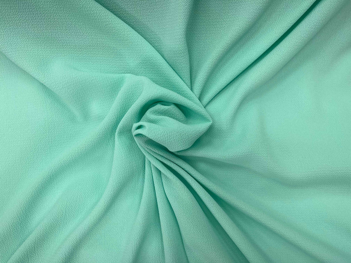 Mint-colored plain bubble georgette fabric by Cheap Fabrics, showcasing soft, lightweight georgette material with a textured bubble pattern.