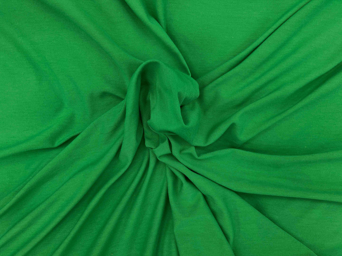 Green cotton mix jersey fabric from Cheap Fabrics, showing a soft, plain-colored knit textile ideal for clothing and crafts.