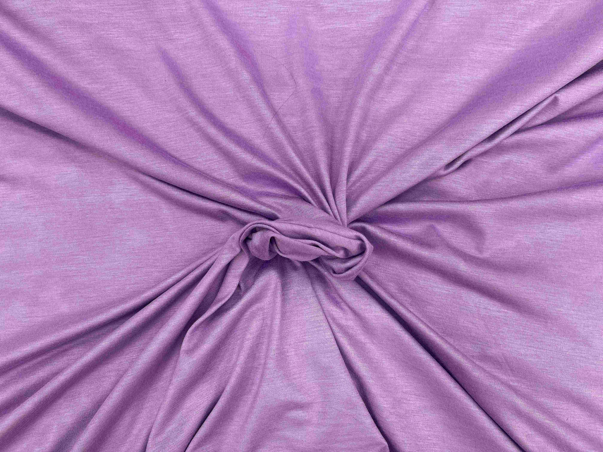 Lilac cotton mix jersey fabric from Cheap Fabrics, showing soft, plain-colored knit textile ideal for clothing and craft projects.