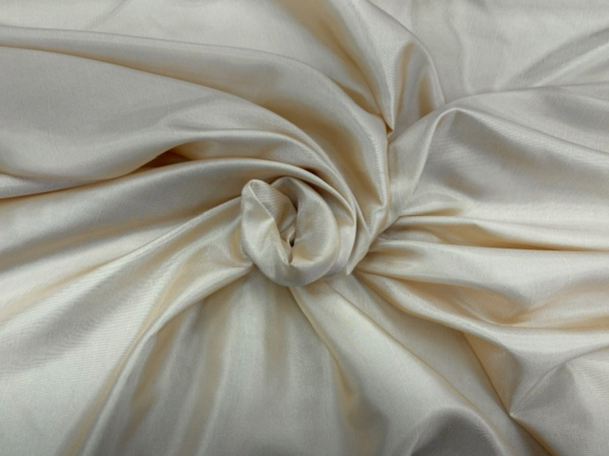 Cream taffeta fabric from Cheapfabrics, showing smooth, shiny, lightweight material with a subtle sheen.