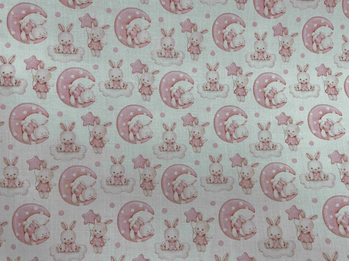 Pink polycotton printed fabric featuring cute bunny designs, ideal for crafting and sewing projects by Cheap Fabrics.