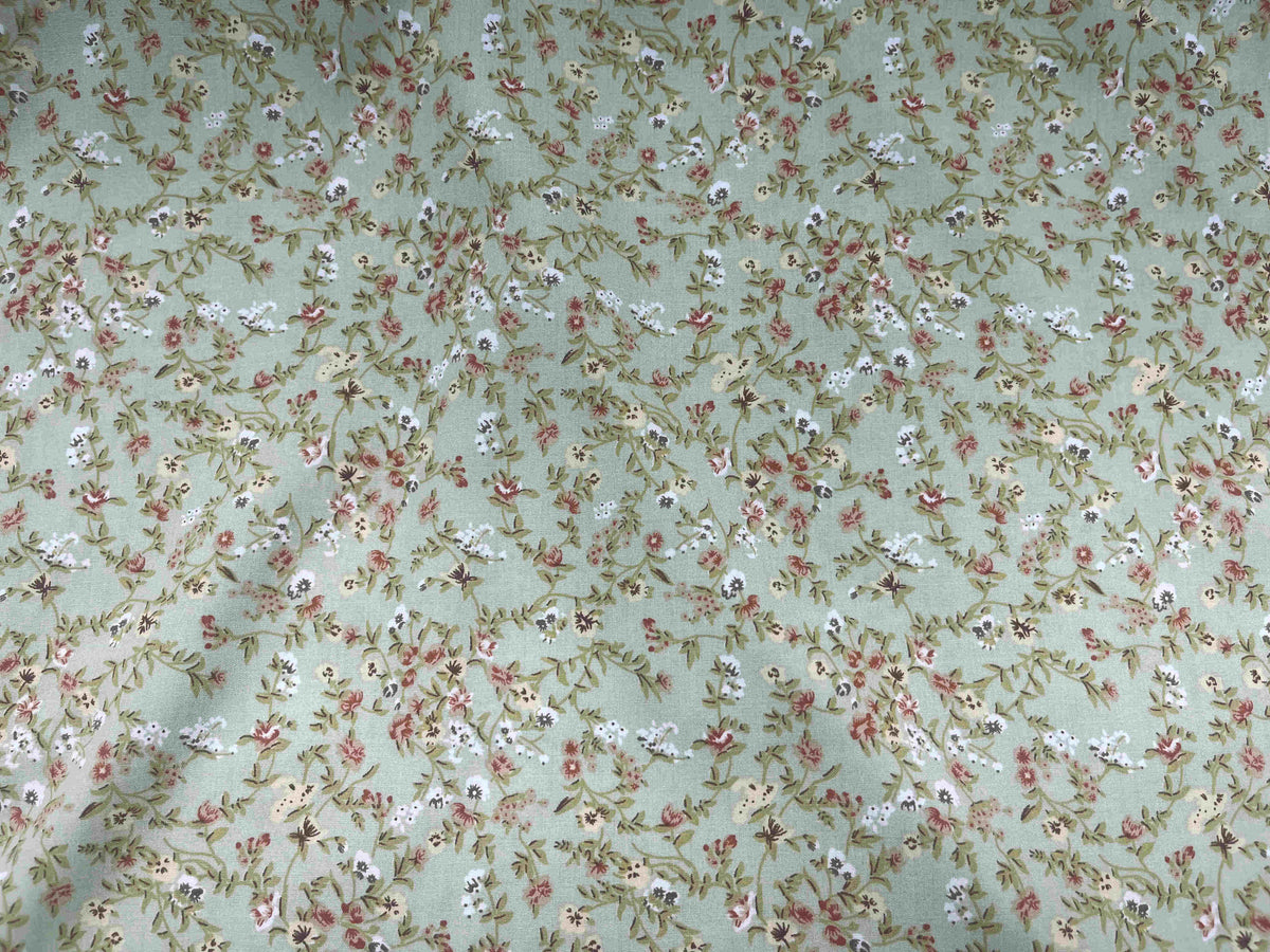 Deluxe printed viscose fabric with a micro floral pattern in pale green, from Cheap Fabrics.