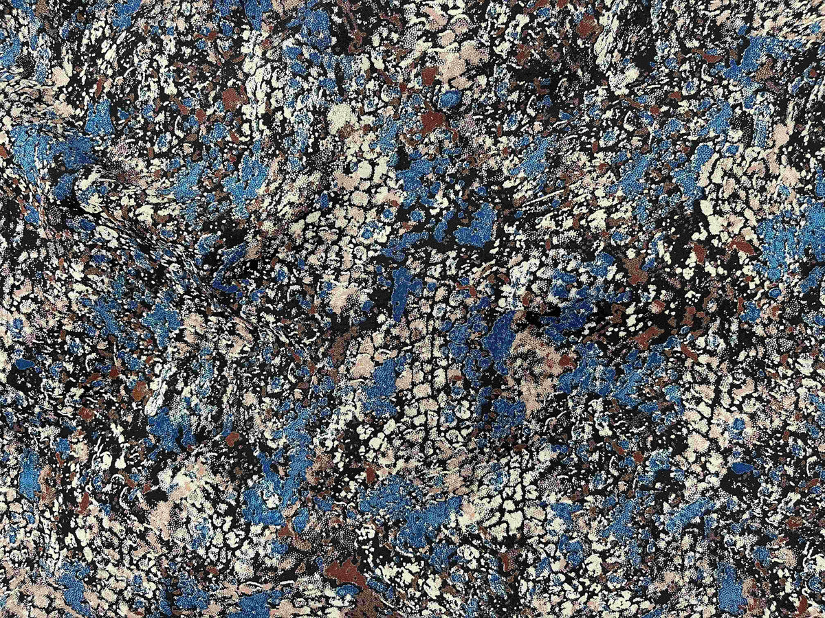 Discharge printed viscose fabric with geology-inspired design, showcasing vibrant colors and detailed patterns.