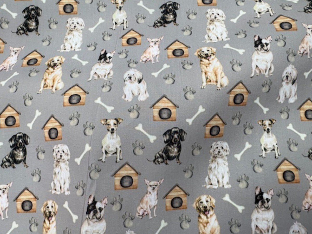Grey polycotton printed fabric featuring playful dog and bone patterns, ideal for sewing projects and crafts.