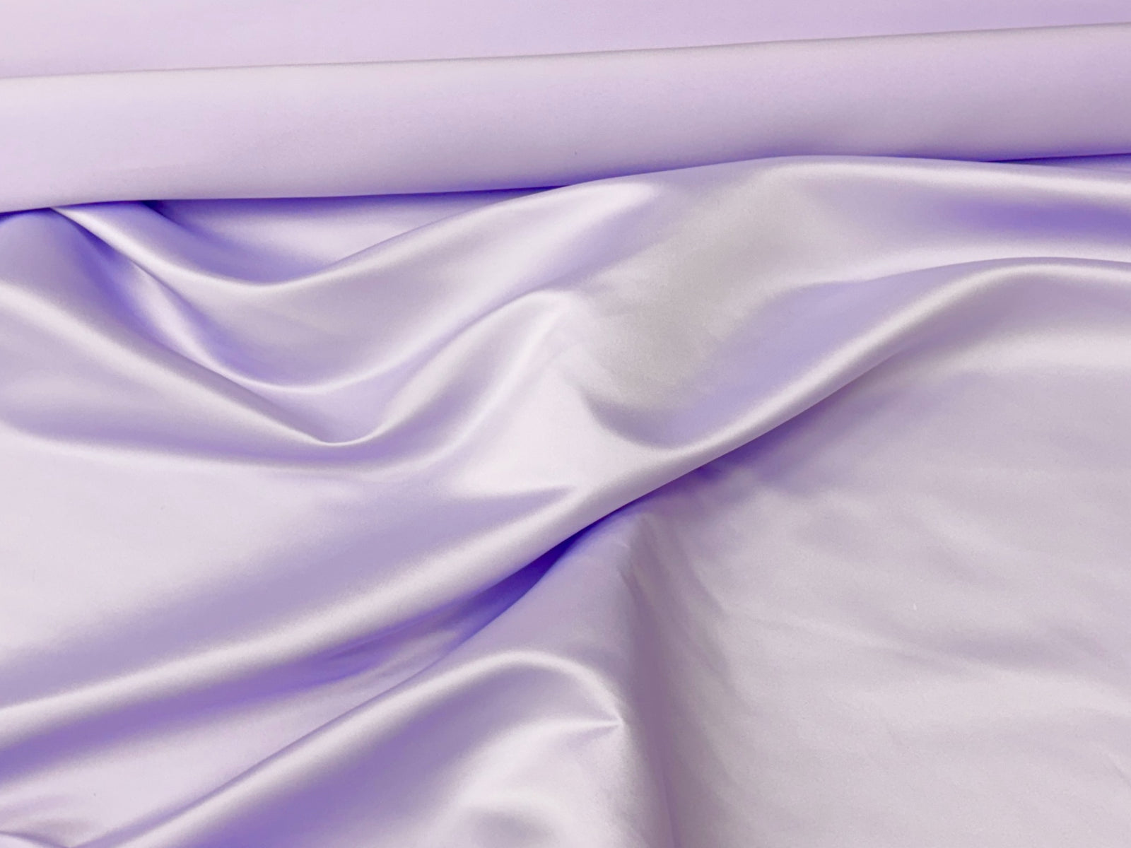 Lilac Duchess Satin fabric by Cheap Fabrics showing smooth, shiny satin material with elegant texture and rich color.