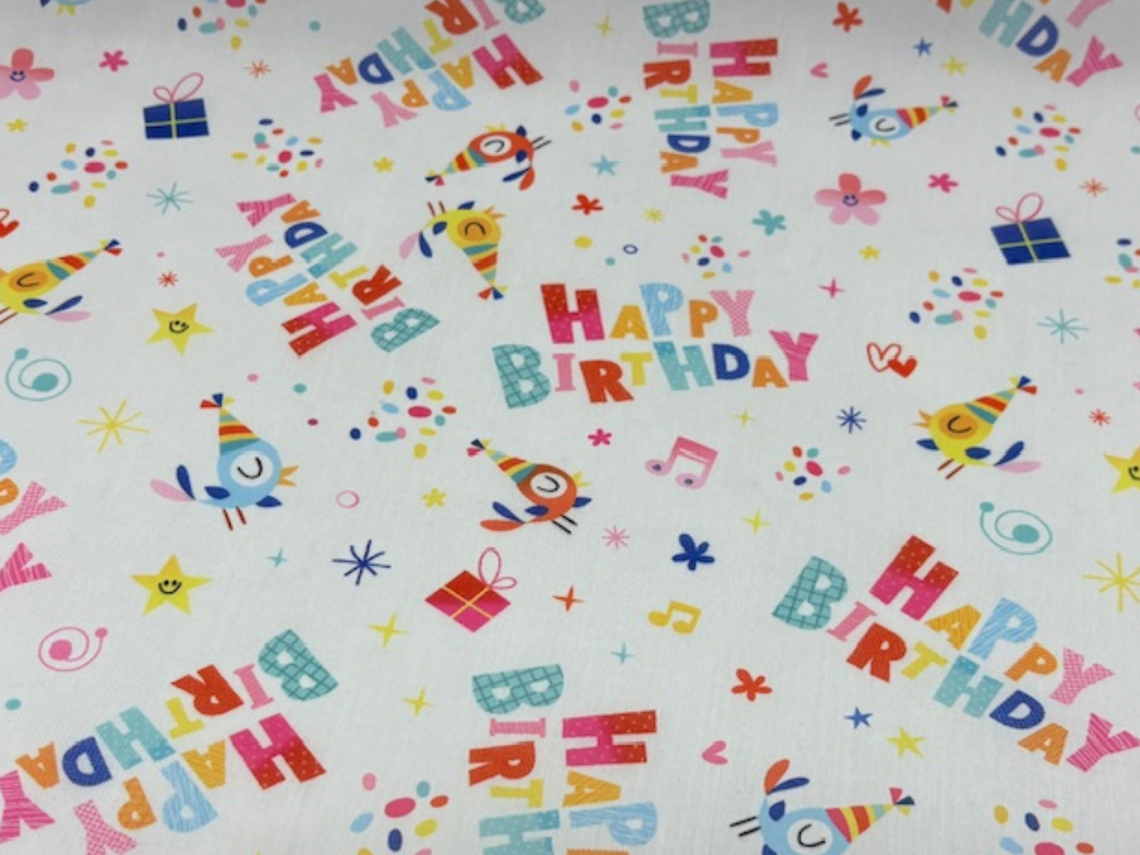 Poly/Cotton fabric with a Happy Birthday print, featuring colorful birthday-themed designs on soft, durable material by Cheap Fabrics