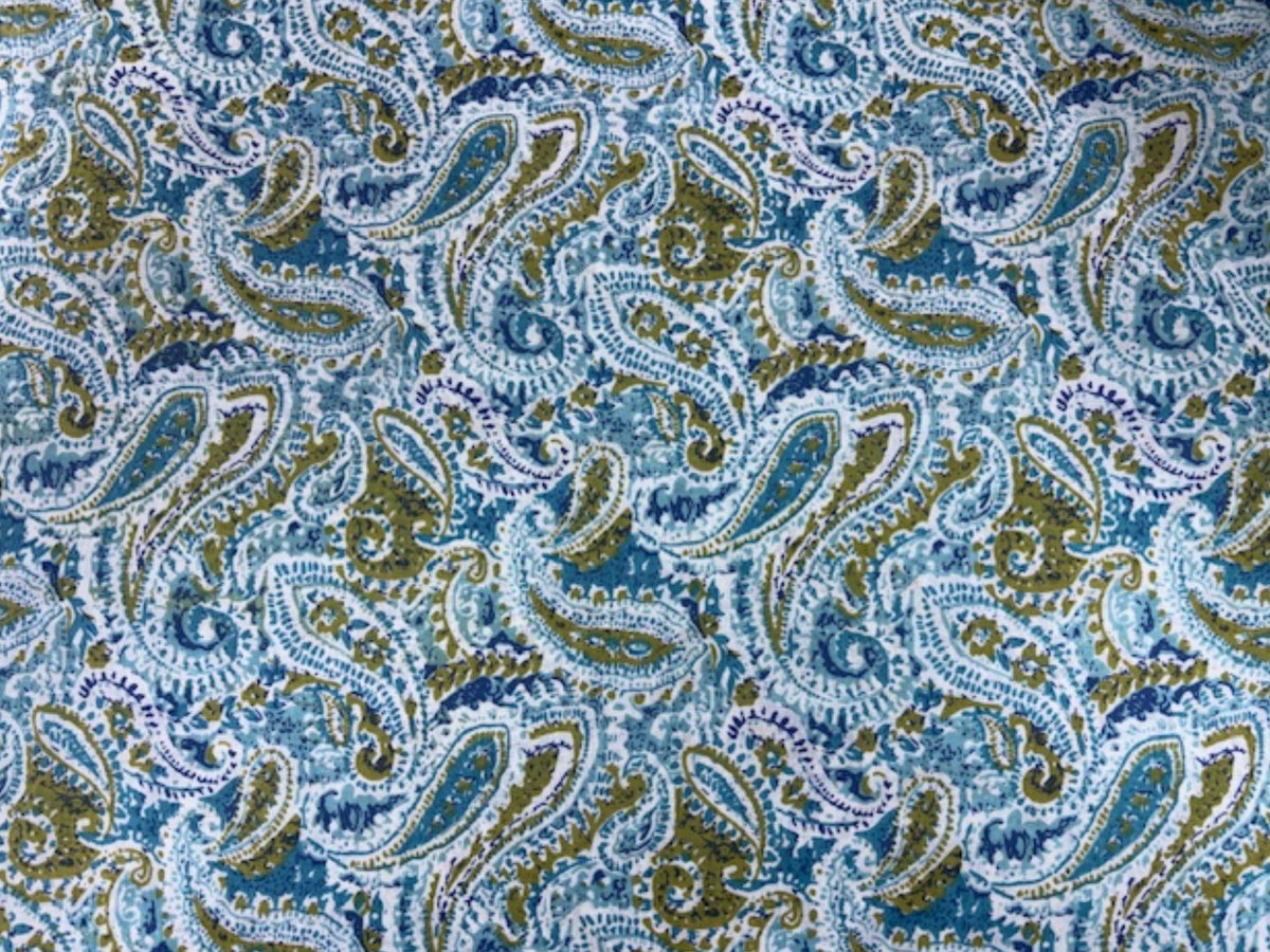 Indian ethnic cotton fabric with paisley print in vibrant hues, showcasing traditional design and soft, breathable cotton material.