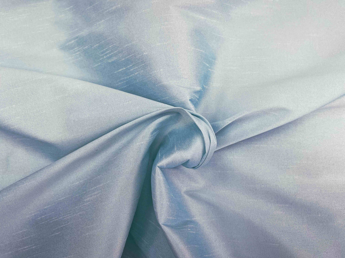 Pale blue Indian raw silk faux fabric from Cheap Fabrics, showcasing smooth, glossy textured silk material for clothing or crafts.