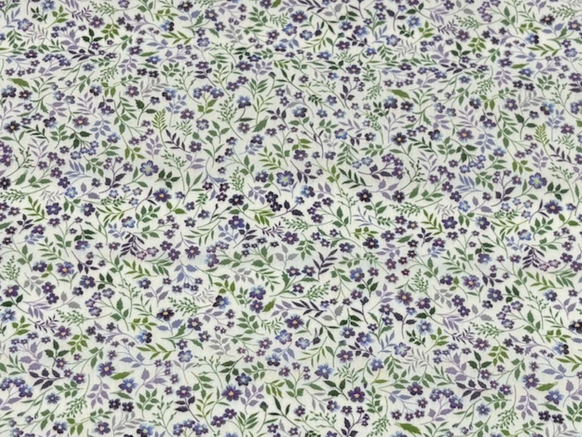 Light purple leafy ditsy floral polycotton fabric from Cheap Fabrics, showing a close-up of the soft, printed textile pattern.