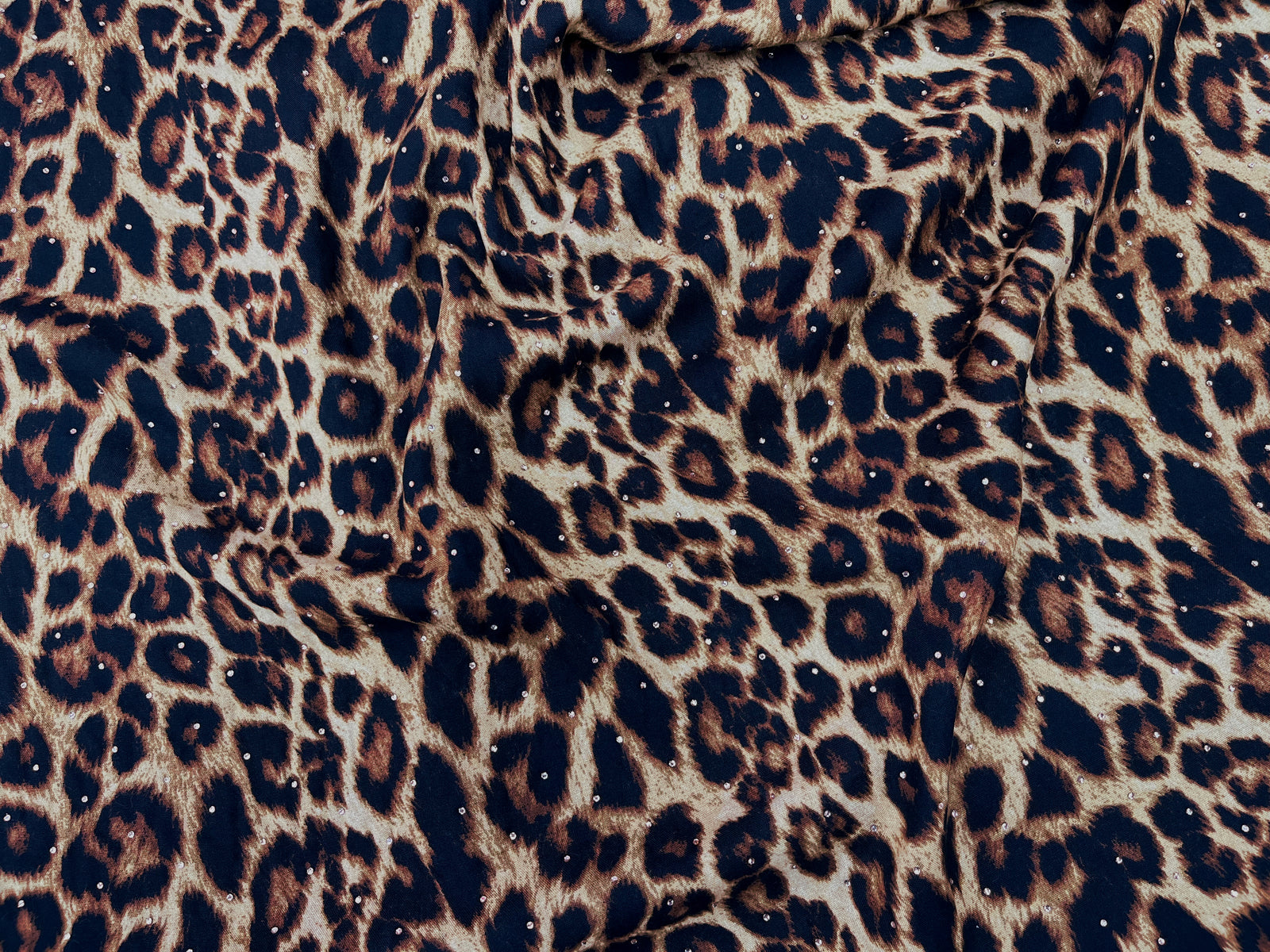 Leopard Dew Drop printed viscose fabric from Cheapfabrics showing a vibrant leopard print pattern on soft fabric.