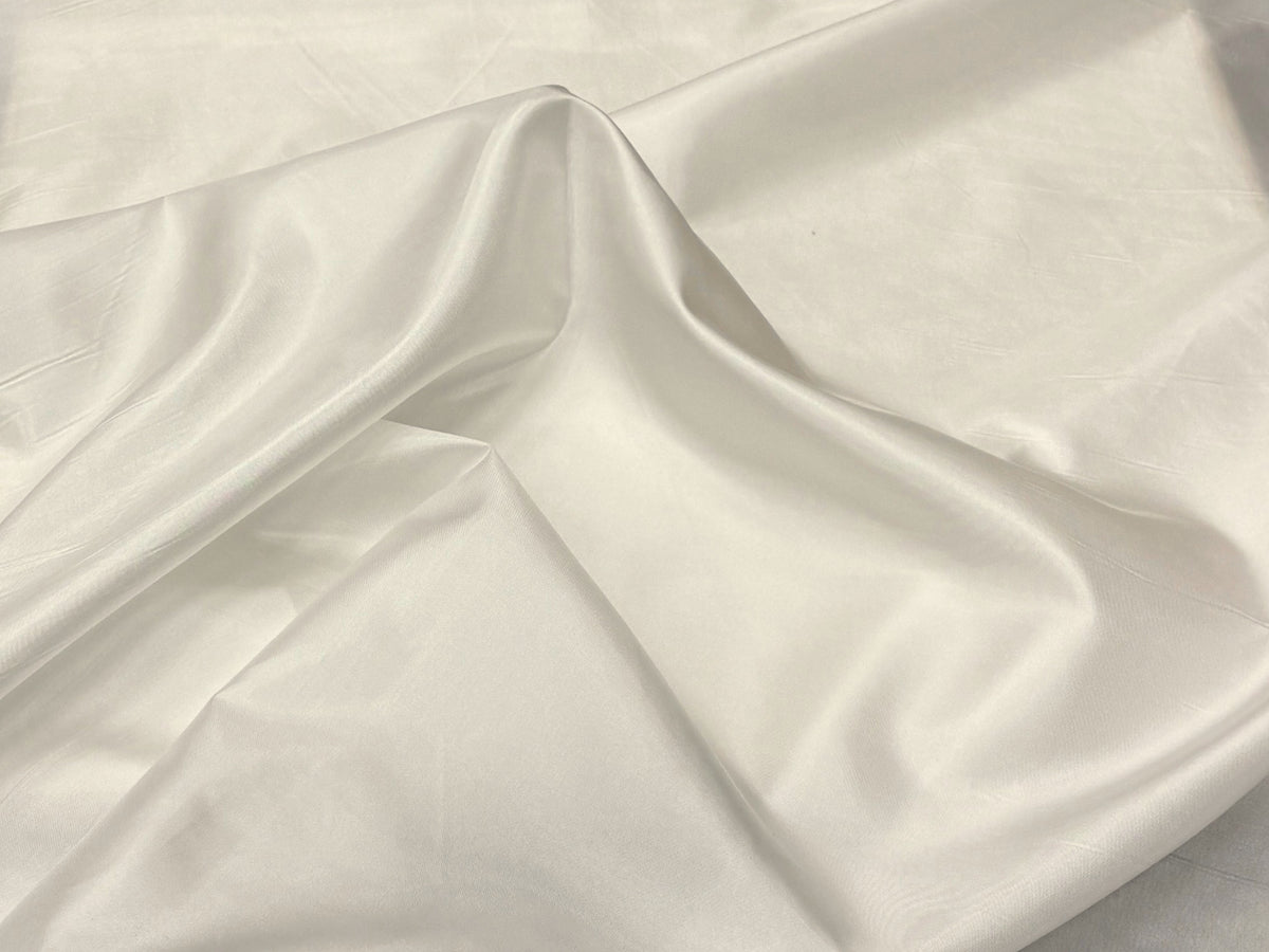 Ivory lining fabric from Cheap Fabrics, close-up of soft, smooth lining material suitable for garment linings.