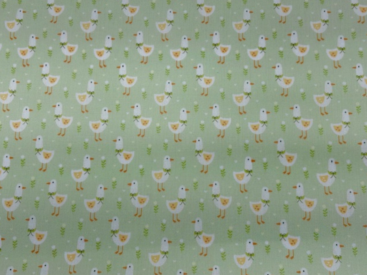 Apple green Little Duck print polycotton fabric by Cheap Fabrics, showing a soft, woven textile with duck pattern design.