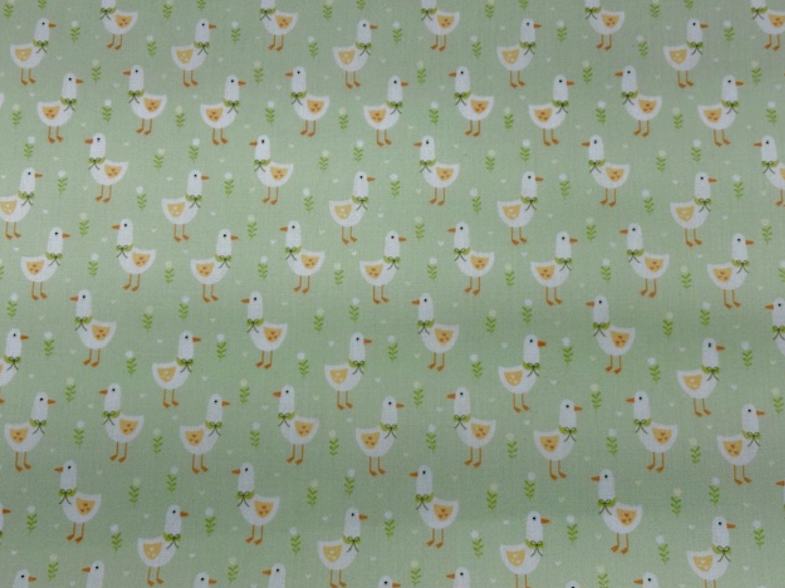 Apple green Little Duck print polycotton fabric by Cheap Fabrics, showing a soft, woven textile with duck pattern design.