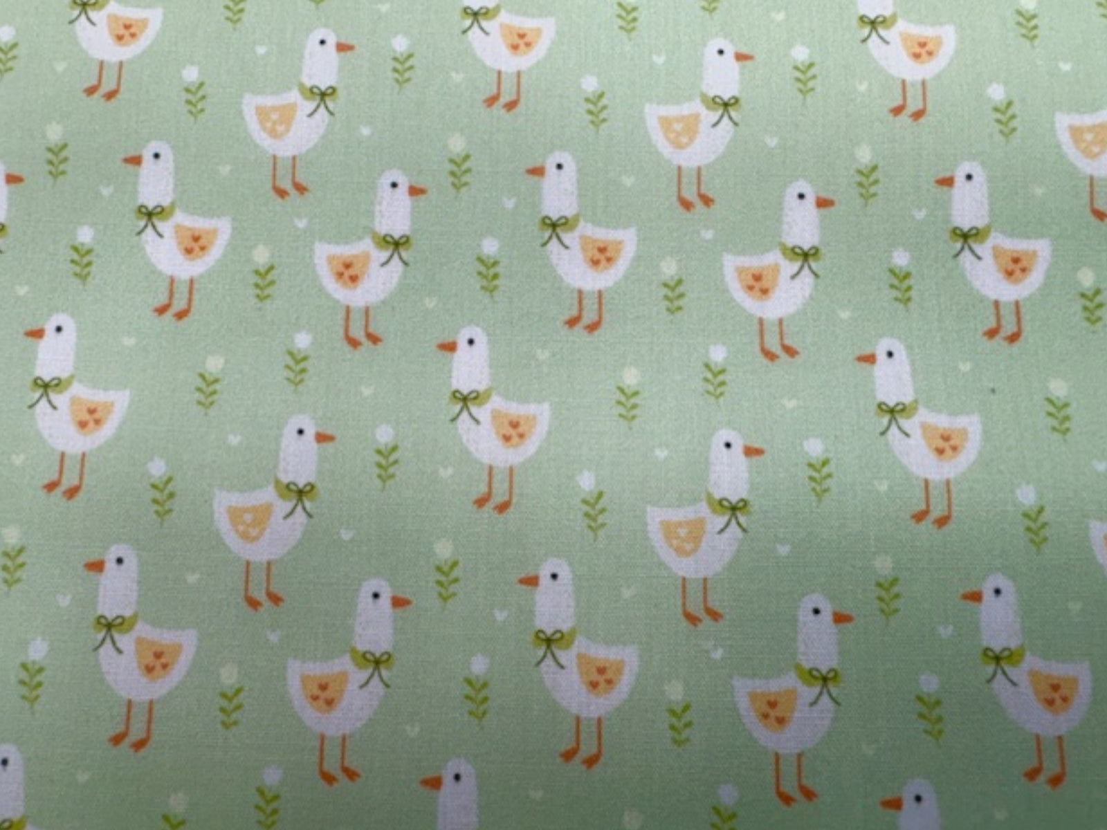 Apple green Little Duck print polycotton fabric by Cheap Fabrics, showing a soft, woven textile with duck pattern design.
