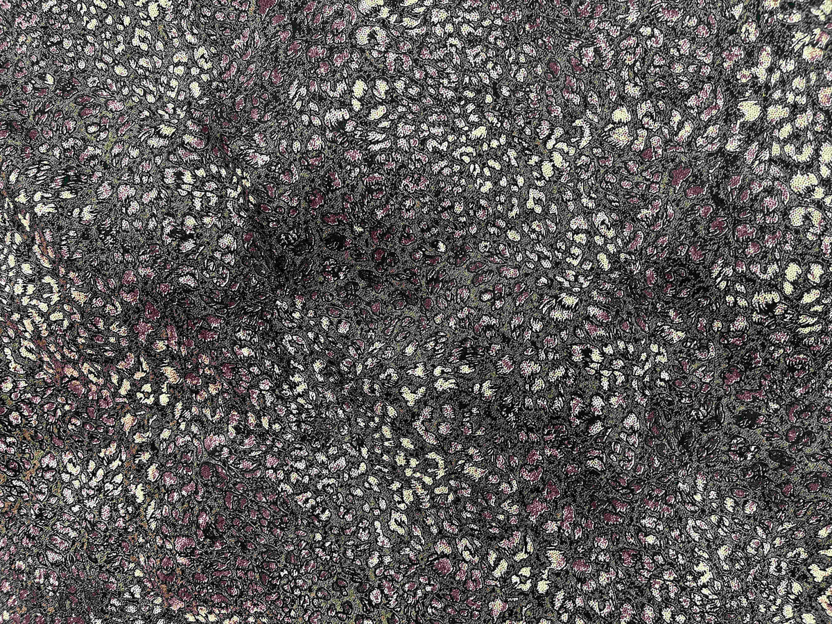 Brown modal jersey fabric with an abstract animal print, soft and stretchy material ideal for comfortable clothing and accessories.
