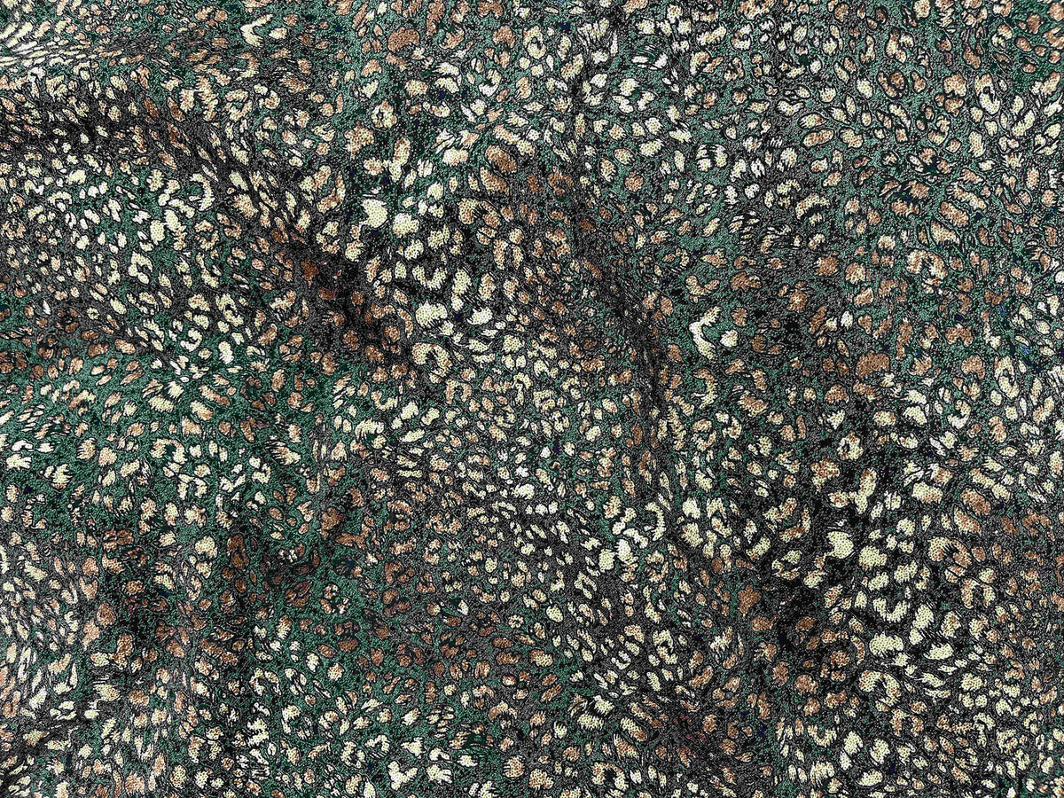 Olive green modal jersey fabric with abstract animal print, showcasing soft, smooth textile ideal for apparel by Cheapfabrics.