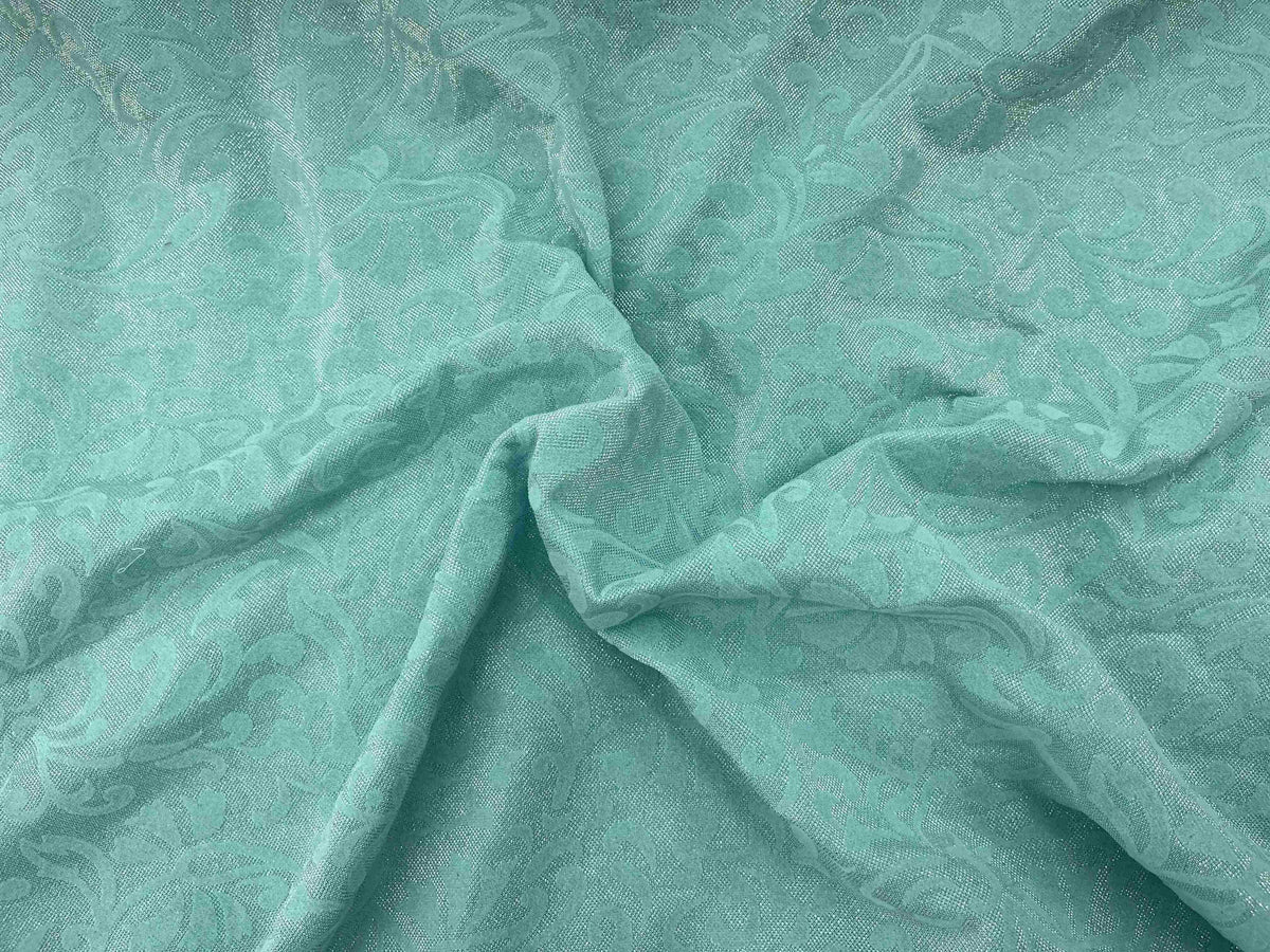 Aqua Moonlight Flock Jersey Fabric displaying soft texture and unique flocked design on a smooth surface.
