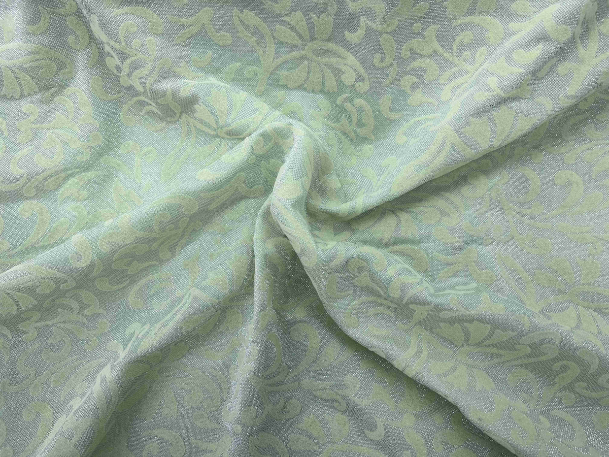 Pea green Moonlight Flock jersey fabric featuring a soft texture and unique pattern, ideal for various sewing projects.