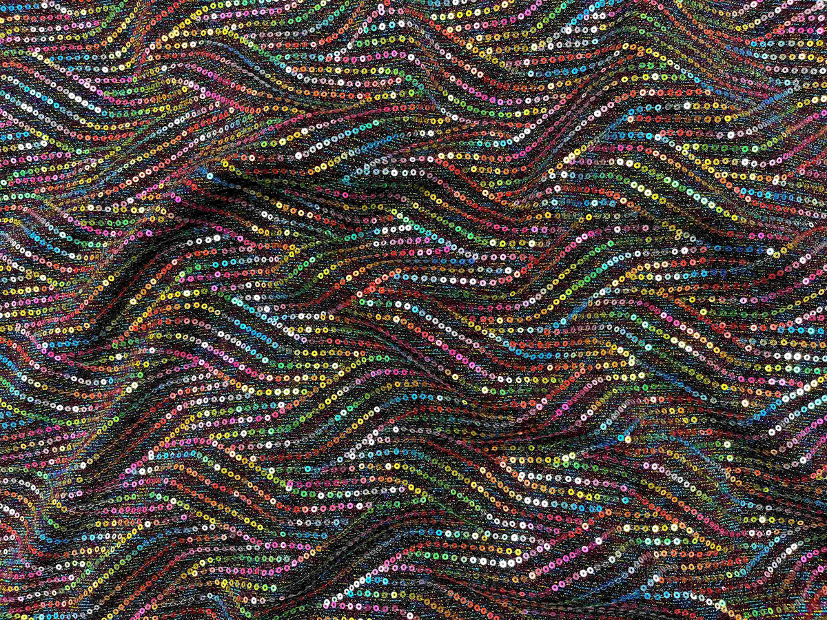 A close-up of aubergine-colored Multi Sequin Jersey Knit Fabric by Cheap Fabrics, showing shiny sequins and soft jersey texture.