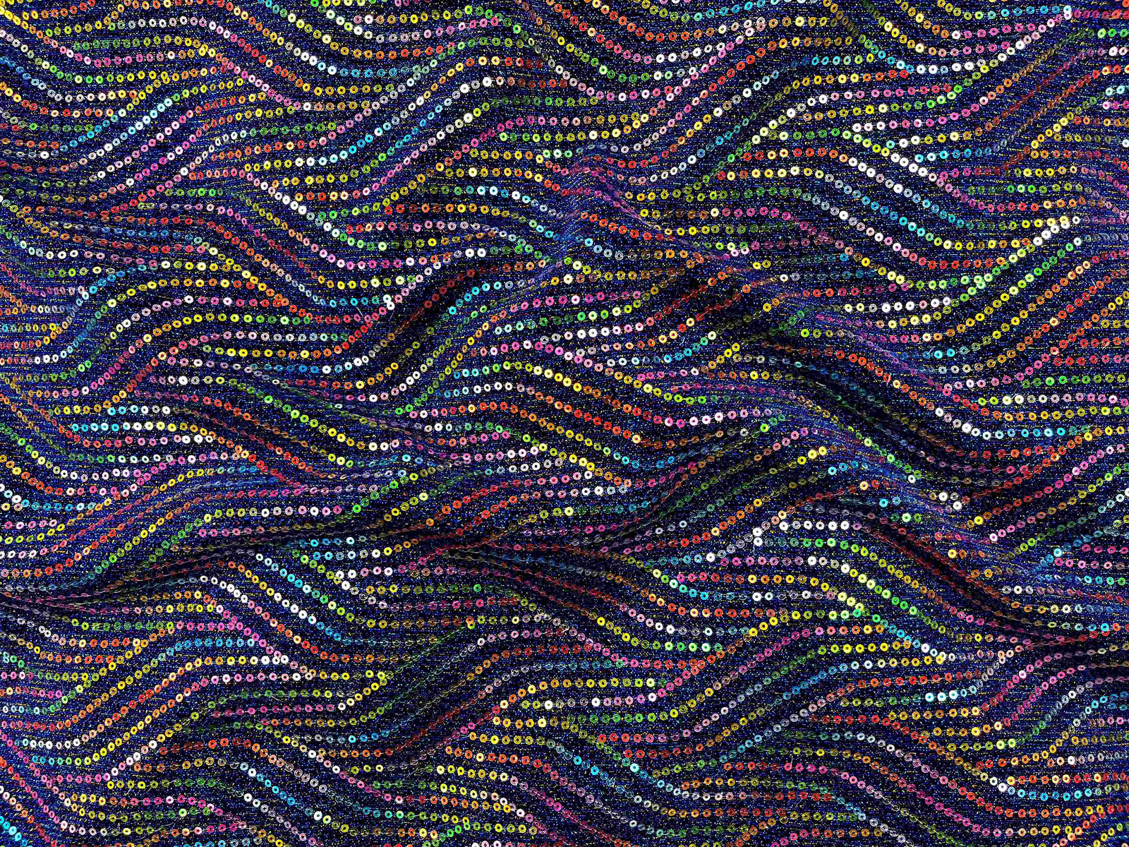 Copper-colored multi sequin jersey knit fabric from Cheap Fabrics, showcasing shiny sequins on soft, stretchable jersey material.