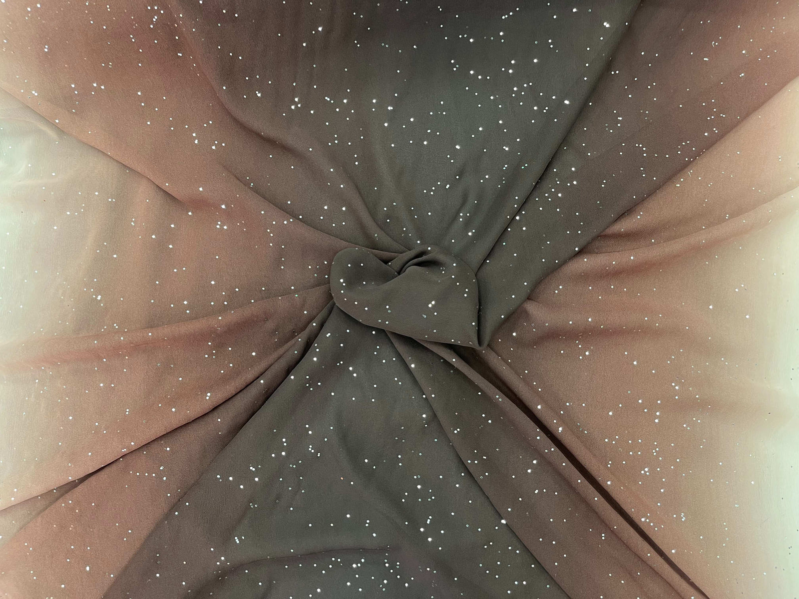 Brown ombre crystal chiffon fabric by Cheap Fabrics, featuring flowing chiffon material with subtle shimmer and gradient color effects.