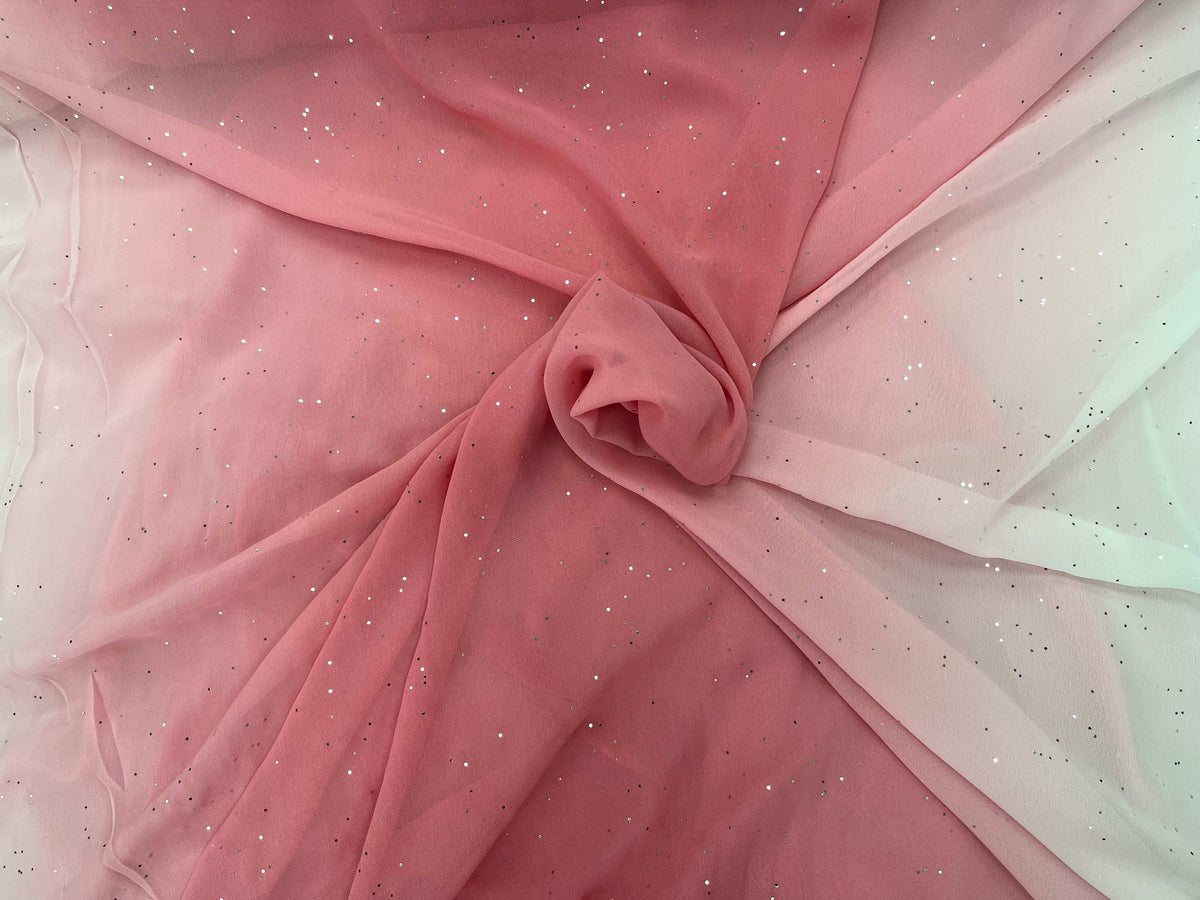 Coral ombre crystal chiffon fabric from Cheap Fabrics showing a flowing, sheer chiffon material with subtle shimmer and gradient color.