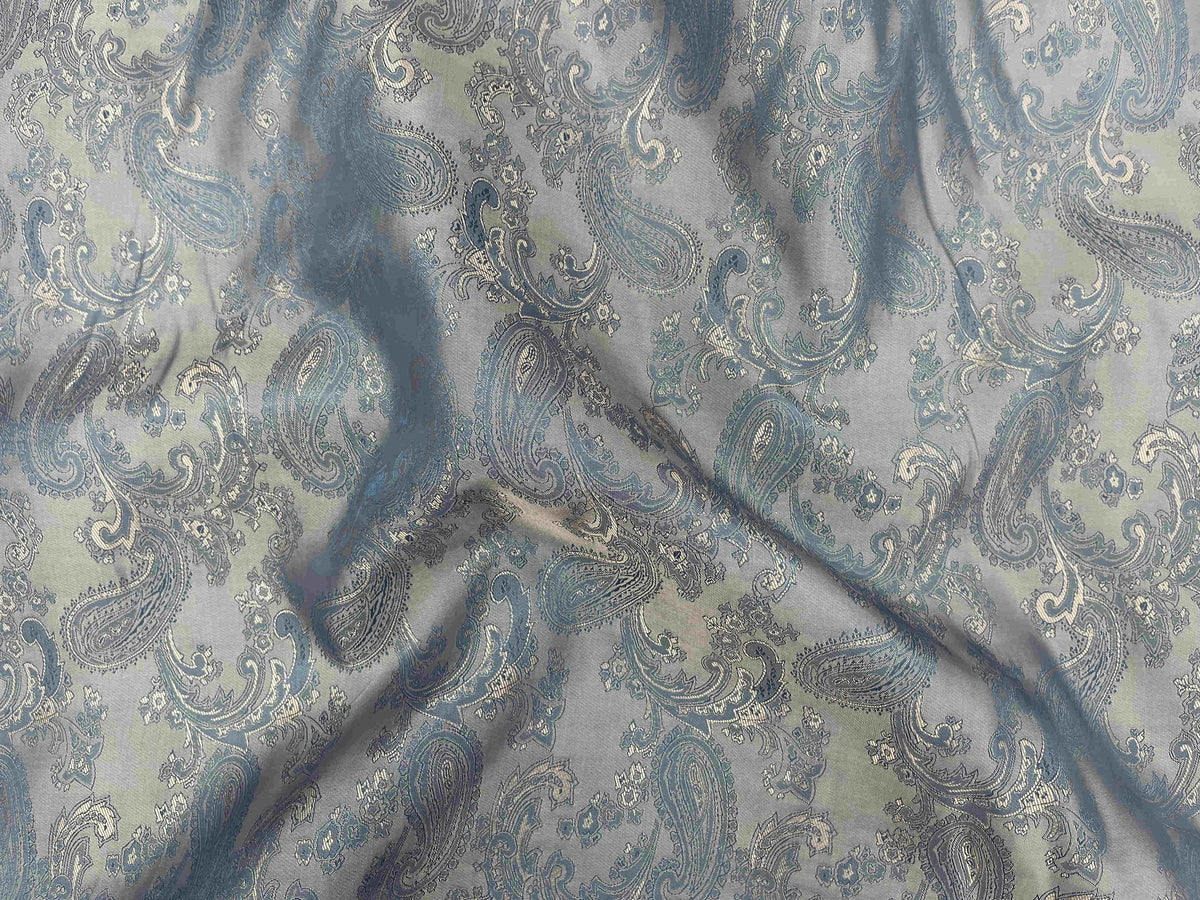 Peach-colored paisley jacquard fabric with self-embossed design, showcasing intricate patterns and textured surface.