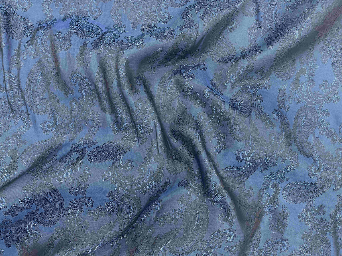 Royal black paisley jacquard fabric with intricate self-embossed design, ideal for elegant upholstery and fashion projects.