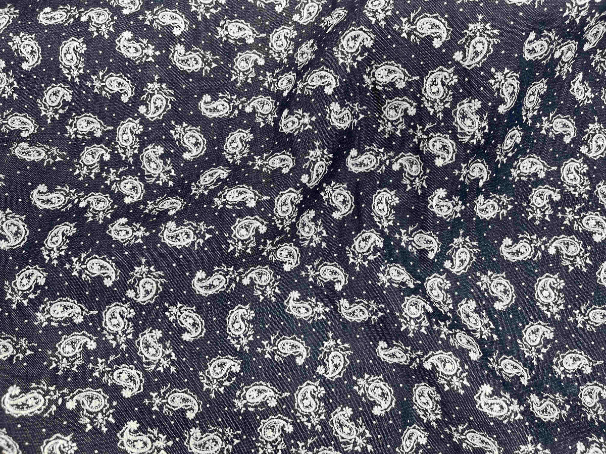 Paisley printed denim fabric by Cheapfabrics showing a detailed pattern on blue denim material.