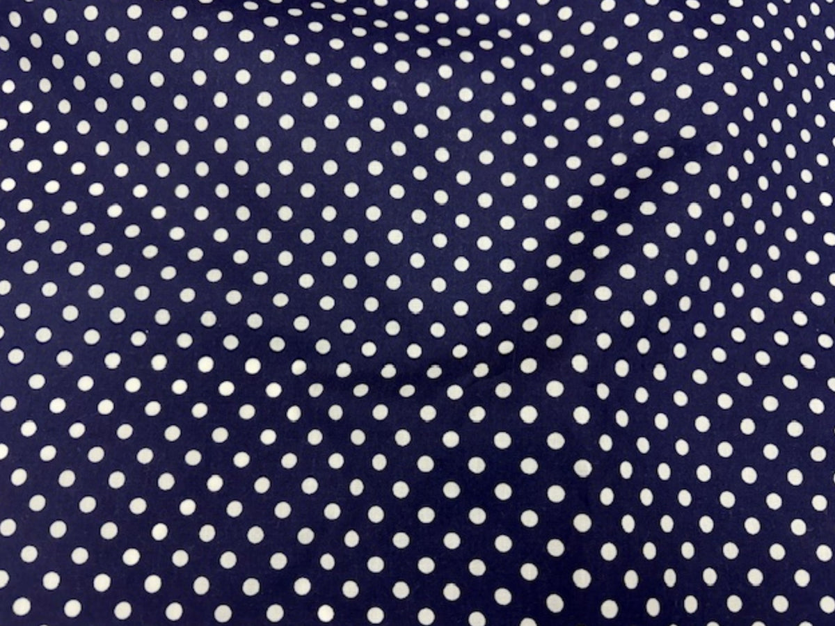 Polka dots polycotton fabric from Cheap Fabrics, featuring a cheerful print with black and white polka dot pattern.