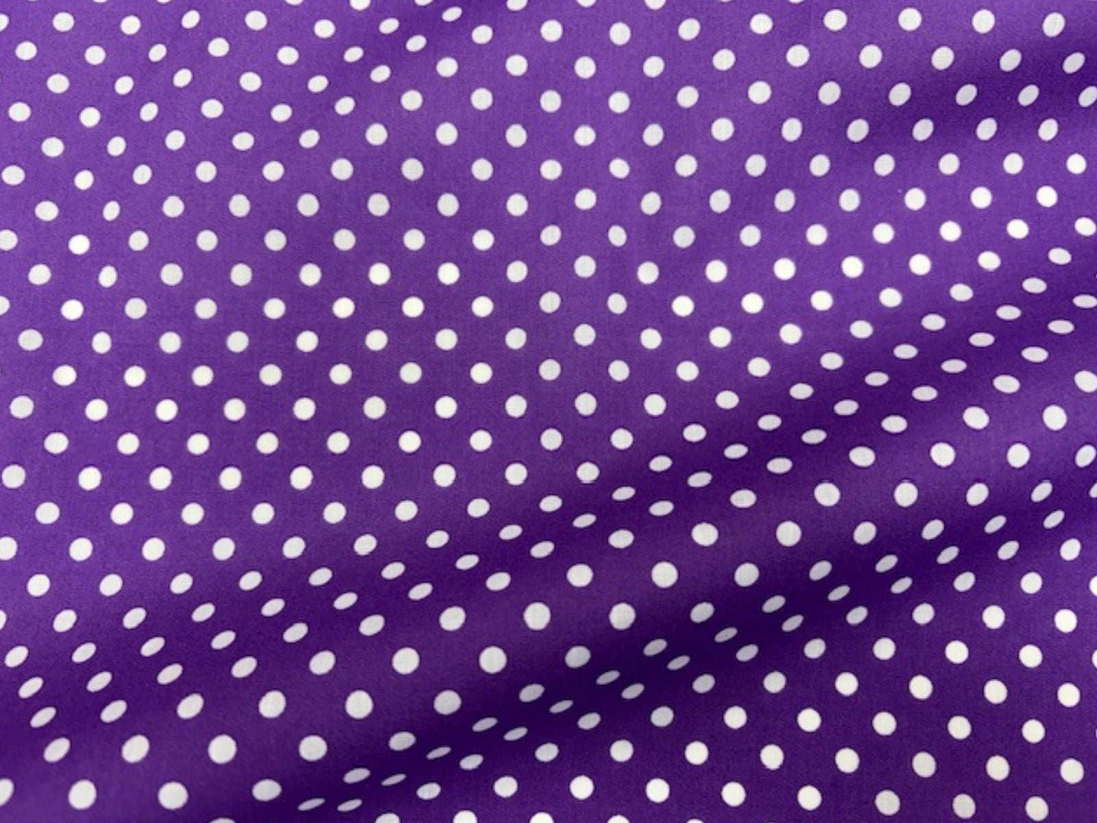 Polka Dots polycotton fabric by Cheap Fabrics with a playful black and white polka dot print on soft, lightweight material.