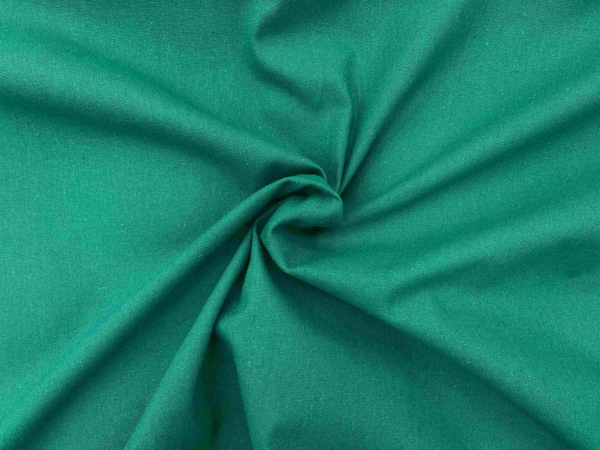 Plain faux linen fabric in jade color, lightweight and smooth textile suitable for upholstery or crafting projects.