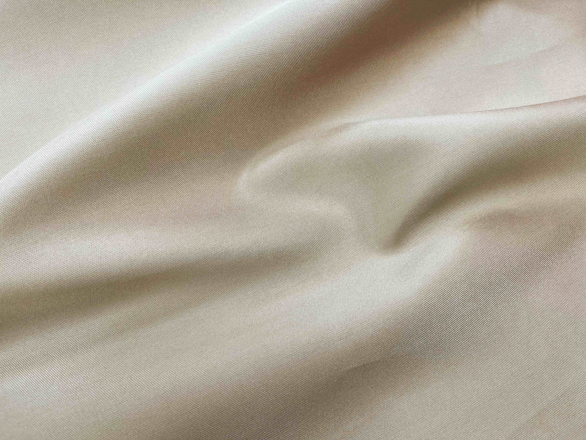 Gold Mikado bridal satin fabric from Cheapfabrics showing smooth, shiny satin texture ideal for elegant wedding dresses.