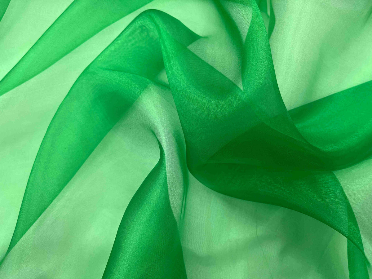 Green shimmer organza fabric from Cheapfabrics, showcasing smooth, transparent material ideal for elegant craft and fashion projects.