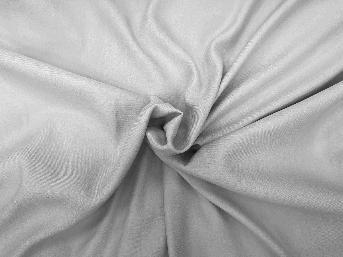 Silver plain viscose satin fabric, smooth and shiny Viscose material from Cheapfabrics, ideal for clothing and upholstery projects.