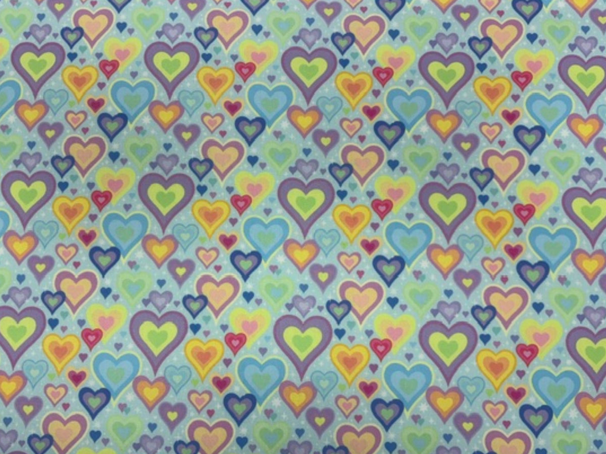 Polycotton printed fabric by Cheap Fabrics featuring pastel aqua hearts pattern, ideal for quilting and craft projects.