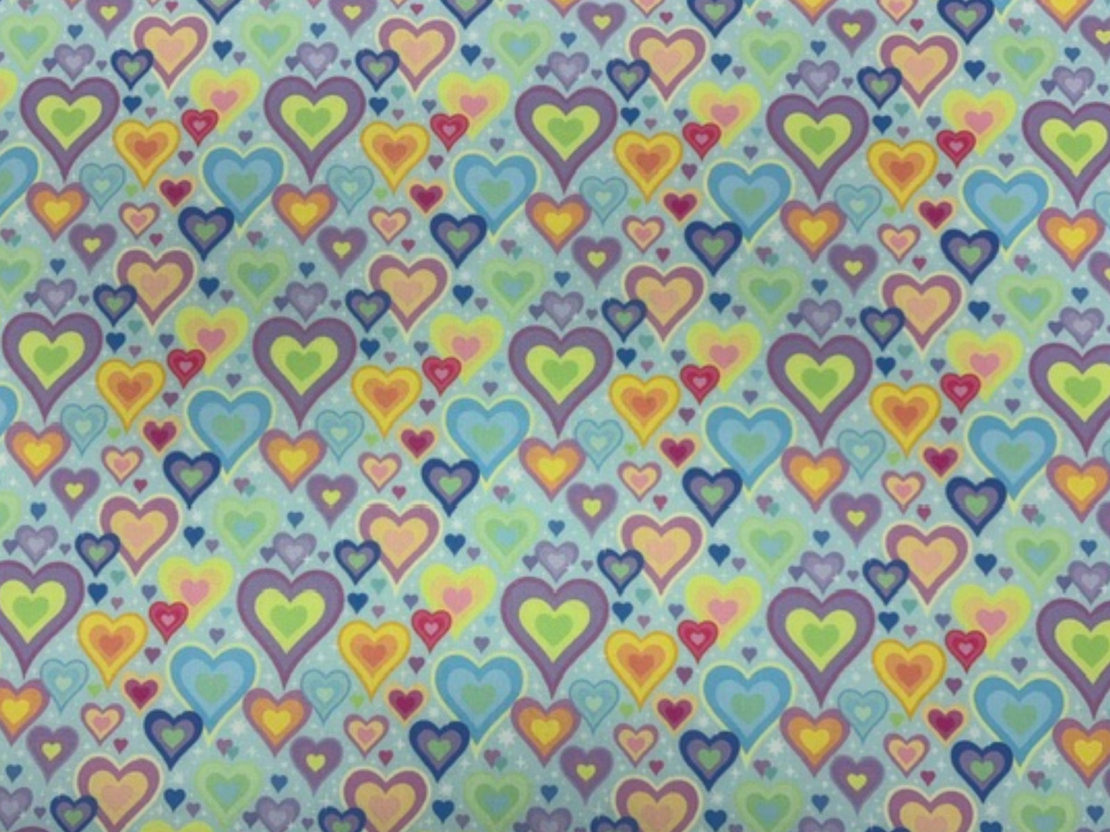 Polycotton printed fabric by Cheap Fabrics featuring pastel aqua hearts pattern, ideal for quilting and craft projects.