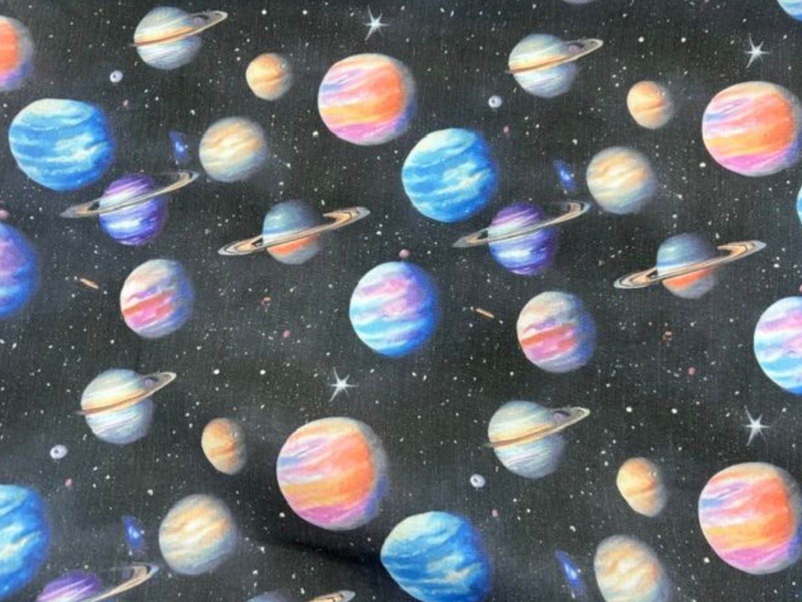 Planets poly/cotton fabric by Cheap Fabrics, featuring colorful planets on a black background
