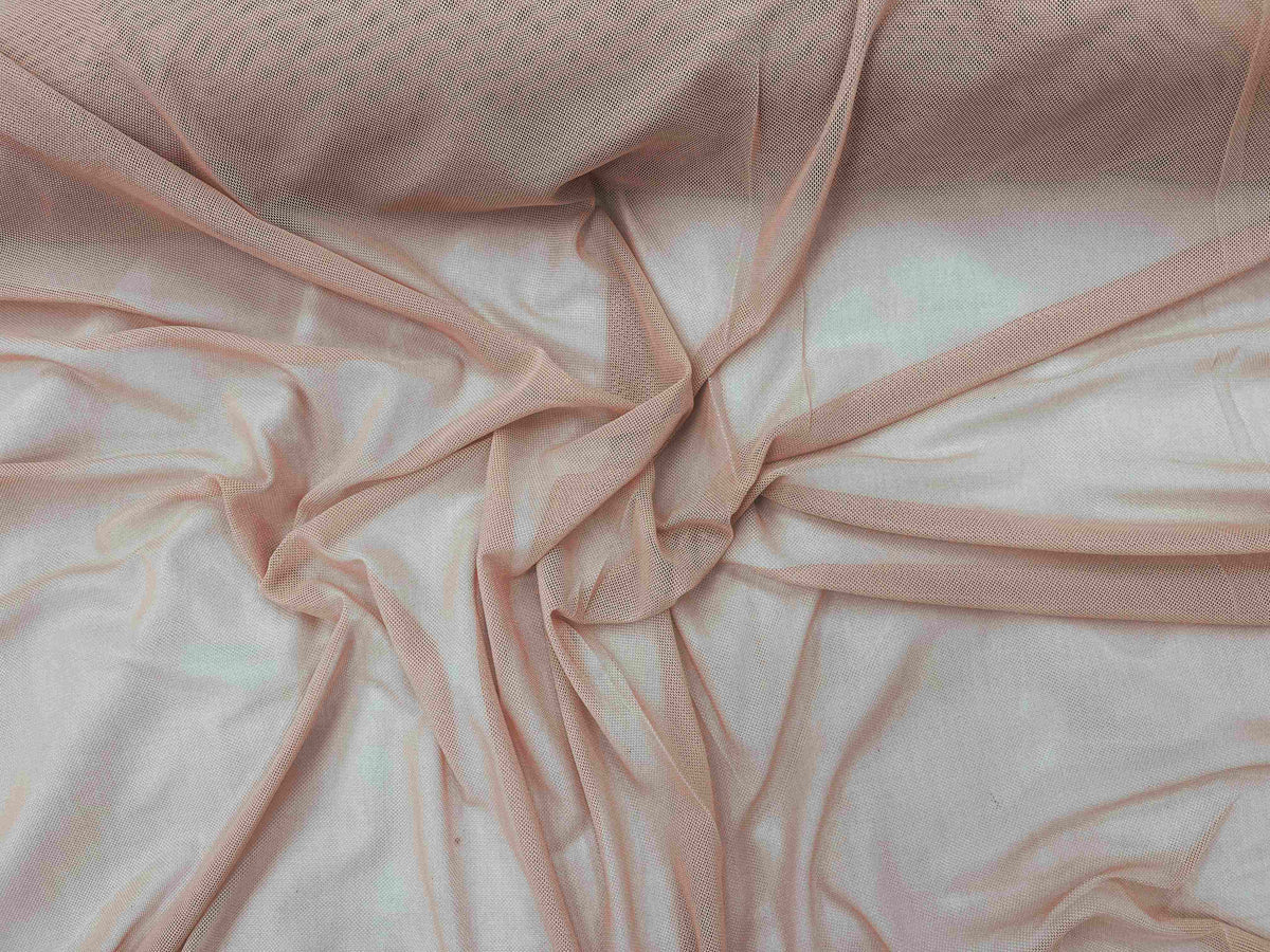 Salmon-colored Power Mesh tulle fabric by Cheap Fabrics, showing its lightweight, stretchy texture suitable for fashion and craft projects.
