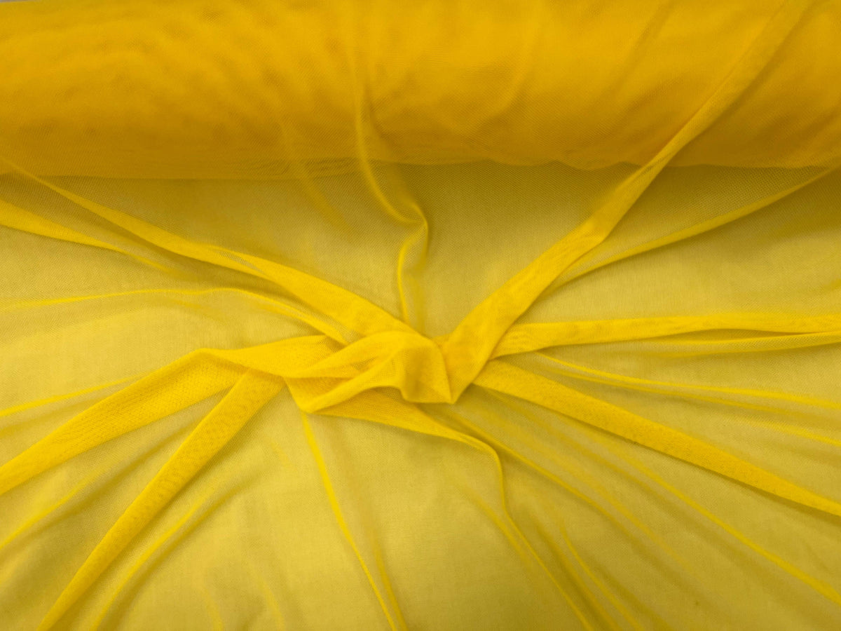 Bright yellow power mesh tulle fabric by Cheap Fabrics, showcasing its lightweight, stretchy texture suitable for fashion and craft projects.
